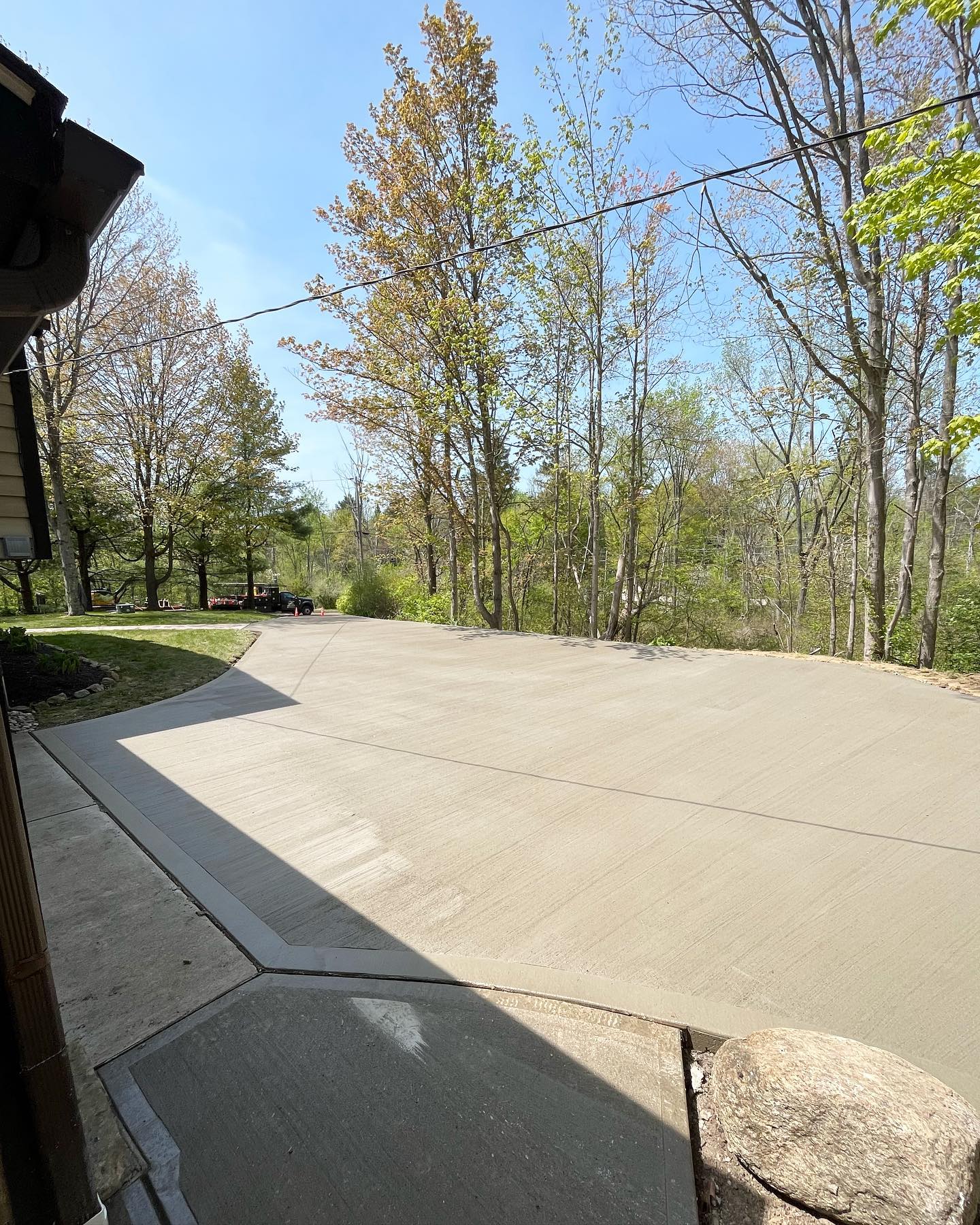 Xpress Construction & Services shows a smooth new driveway at a home, highlighting quality work and tidy surroundings.