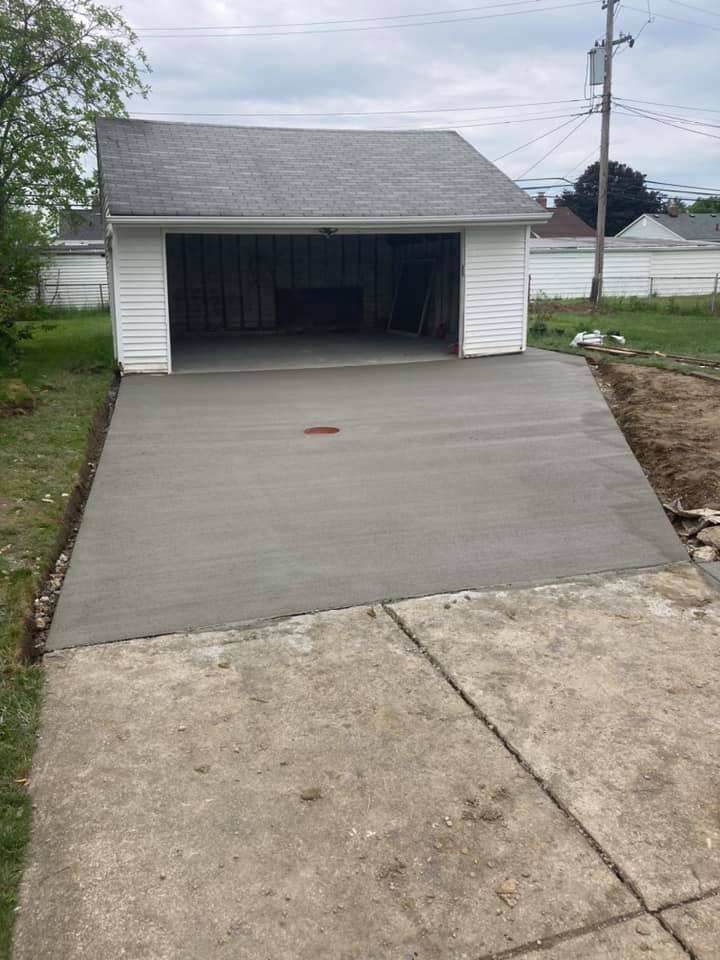 Xpress Construction & Services builds a new concrete driveway, showing quality work at a home still under construction.