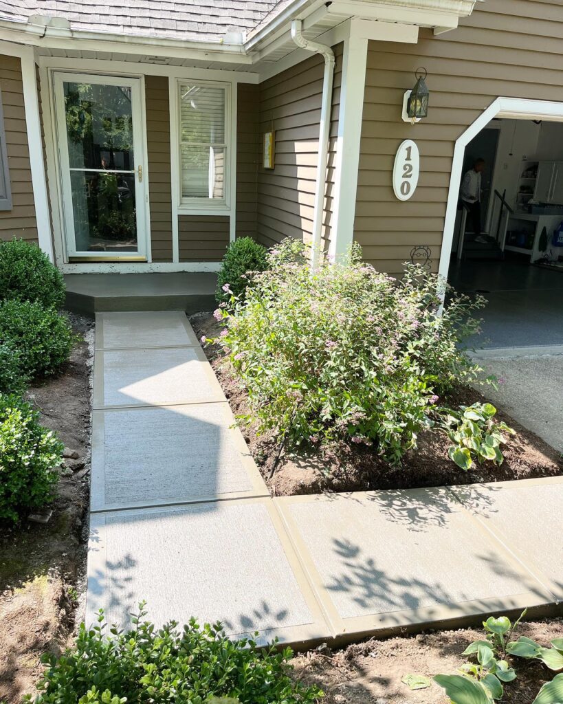 Xpress Construction & Services made a neat walkway that guides people easily to a welcoming tan home at number 120.