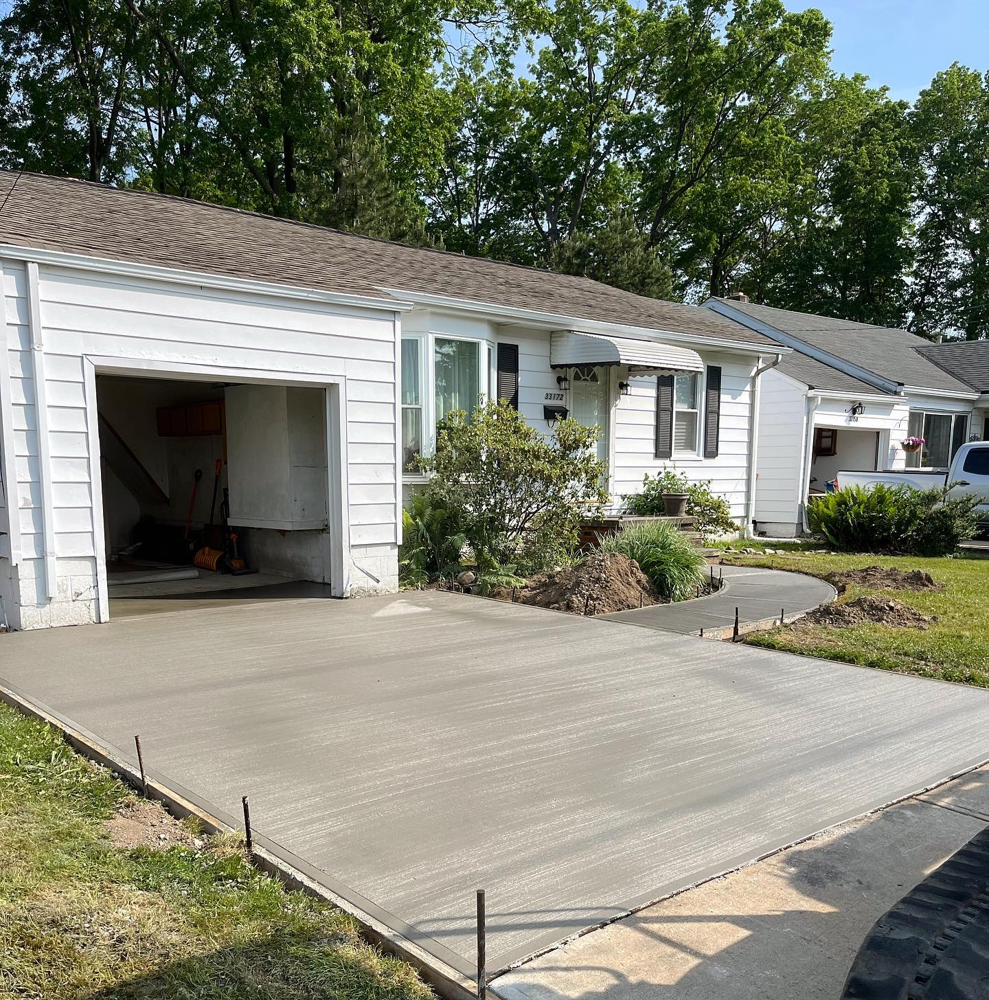 Xpress Construction & Services shows a new concrete driveway for a single-story home, ready for use and curb appeal.