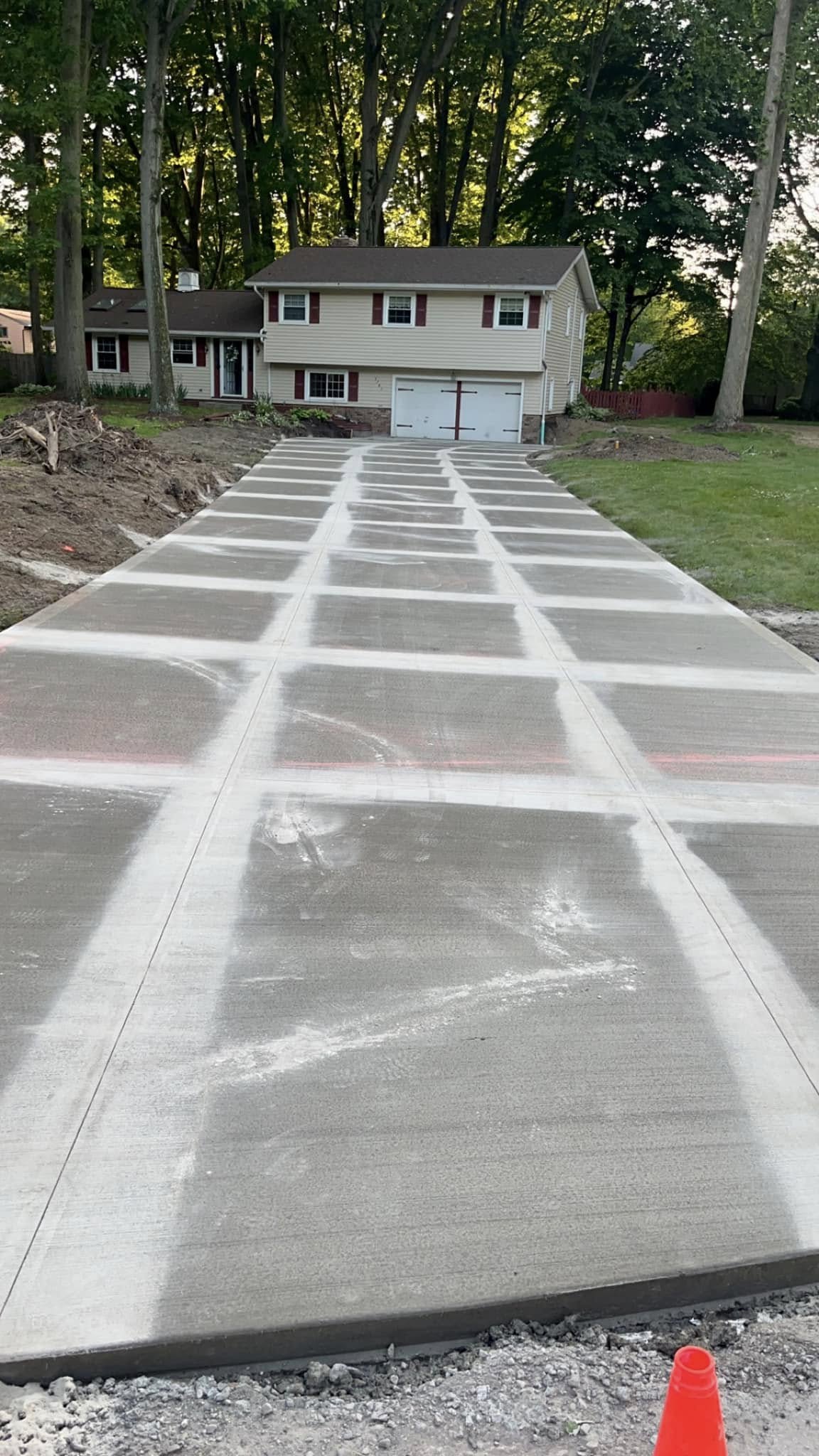 Xpress Construction & Services shows a new, smooth driveway finished in front of a neat house with careful yard work.