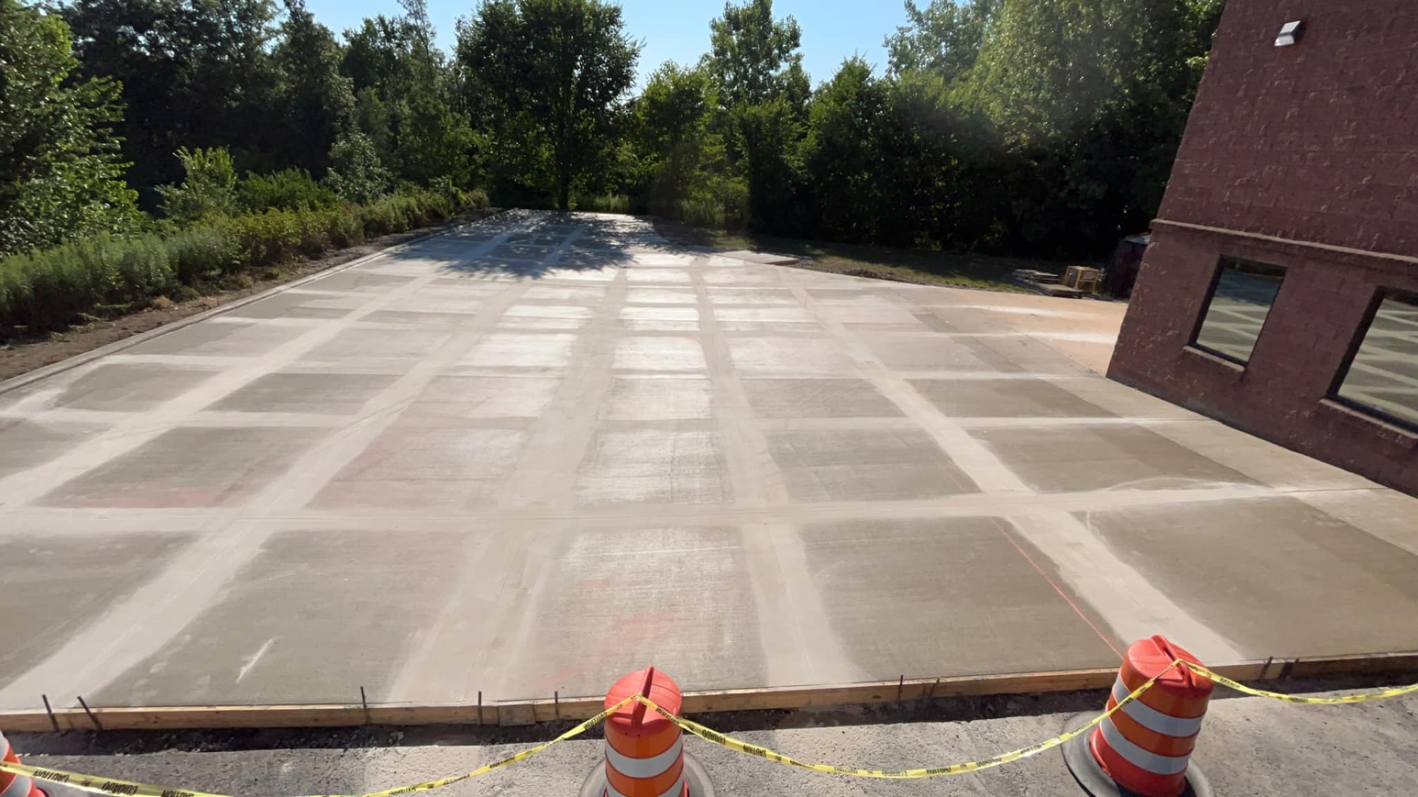 A safe, newly finished parking lot by Xpress Construction & Services is closed off for setting before public use.