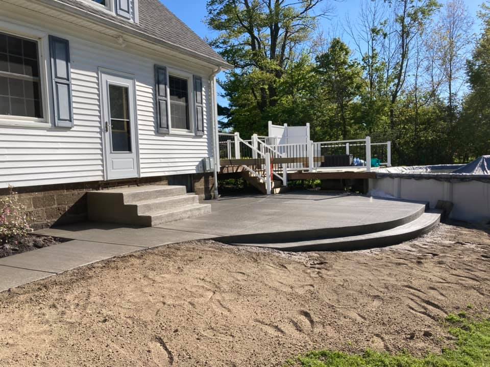 Xpress Construction & Services delivers quality home upgrades with new concrete steps, patio, and pool deck in a yard setting.